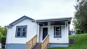 A single-story house with a front porch, a wooden staircase, and a small front yard. - "Rebel Base" in the  Heart of Fayetteville (Fayetteville)