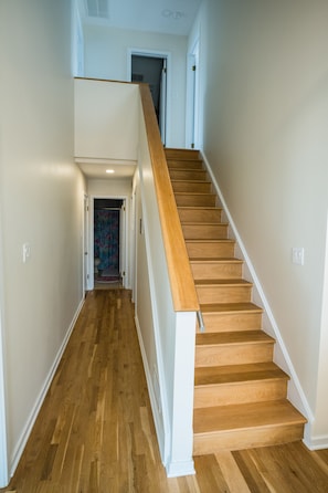 Staircase leads to an upper floor in a central hallway.