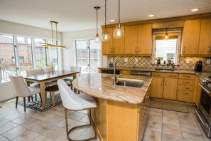 Enjoy cooking and dining in this spacious kitchen with a large island, oven, and dining area.
