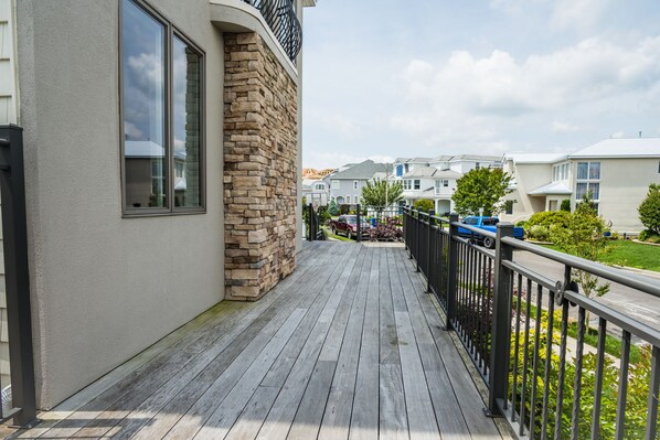 Guests can enjoy a deck with a railing overlooking a serene view.
