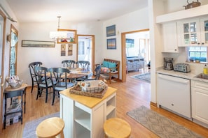 A spacious kitchen with white cabinets, a coffee maker, and a toaster.