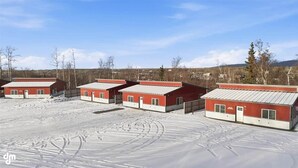 A row of red buildings with flat roofs, arranged in a linear fashion. - Upper Mesa Villa #9, Glacier Suites - Upper Mesa Villa #11 (Palmer)