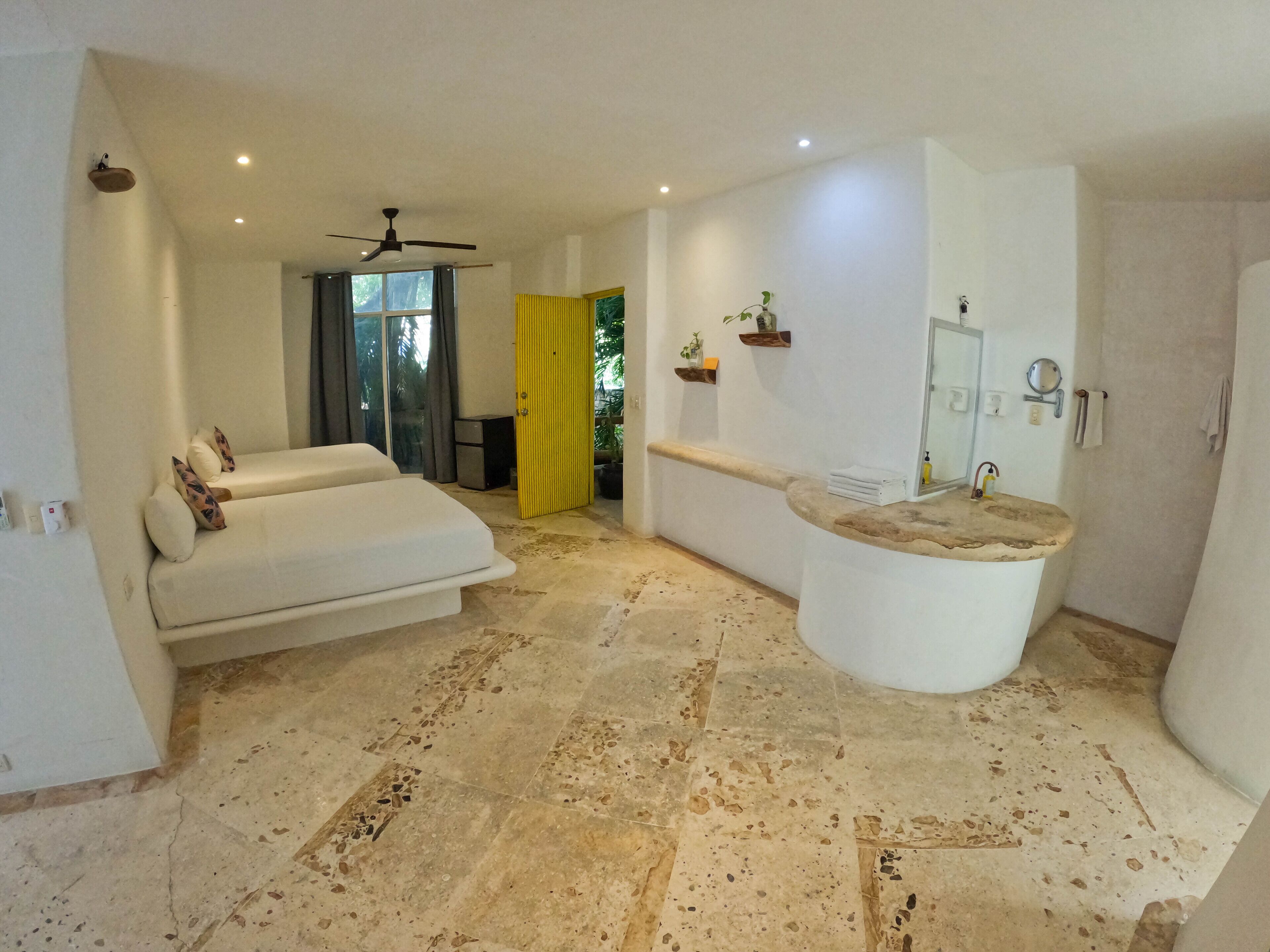A modern bathroom with a freestanding bathtub, a large mirror, and a toilet.