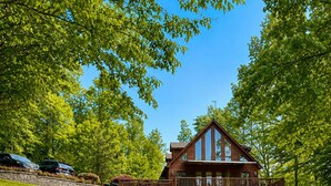 A lodge with a large deck, kayaks, and paddleboards on the grass. - Updated Lakefront Retreat, Fiber WiFi, Fire Pit, 15 Min to VIR (Leasburg)