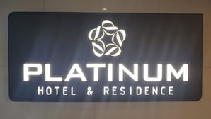 A sign for 'Platinum Hotel & Residence' with a stylized logo above the text. - Platinum Hotel (Busan)