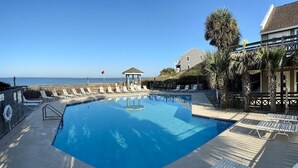 A pool area with lounge chairs and a gazebo, overlooking the beach. - CapeSanBlas Bright, End Unit •Short walk to neighborhood private beach •2 Pools  (Port St. Joe)