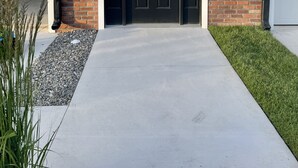 A modern two-story house with a black front door, a garage door, and a small brick section on the lower wall. - Beautiful townhome in Wildwood Crest, walking distance to beach (Wildwood)