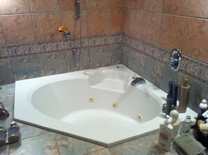 Bathtub, towels, soap, toilet paper