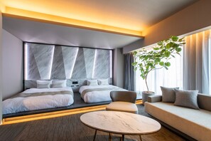 A modern hotel room with a large bed, a sofa, a round table, and a potted plant. - fav HAKODATE (Hakodate)