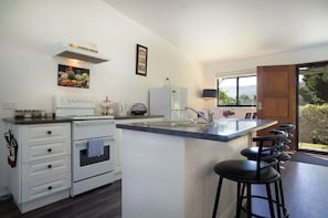 Enjoy cooking in this well-equipped kitchen with a central island, stove, and ample seating.