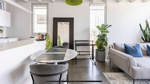 A modern living space with a kitchen, dining area, and seating area.