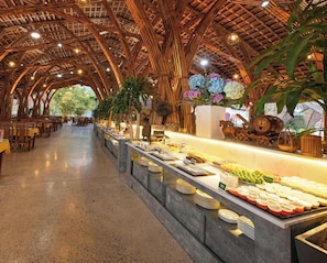 A buffet area with a high, bamboo-like ceiling and a long counter with various food items. - Moc Chau Island - Mountain Park and Resort (Moc Chau)
