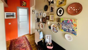 A hallway with a red wall, a white door, and a radiator.