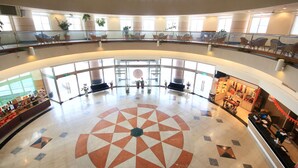 A spacious atrium with a geometric floor design, multiple seating areas, and a central decorative feature. - apvc-resort (Lukang)