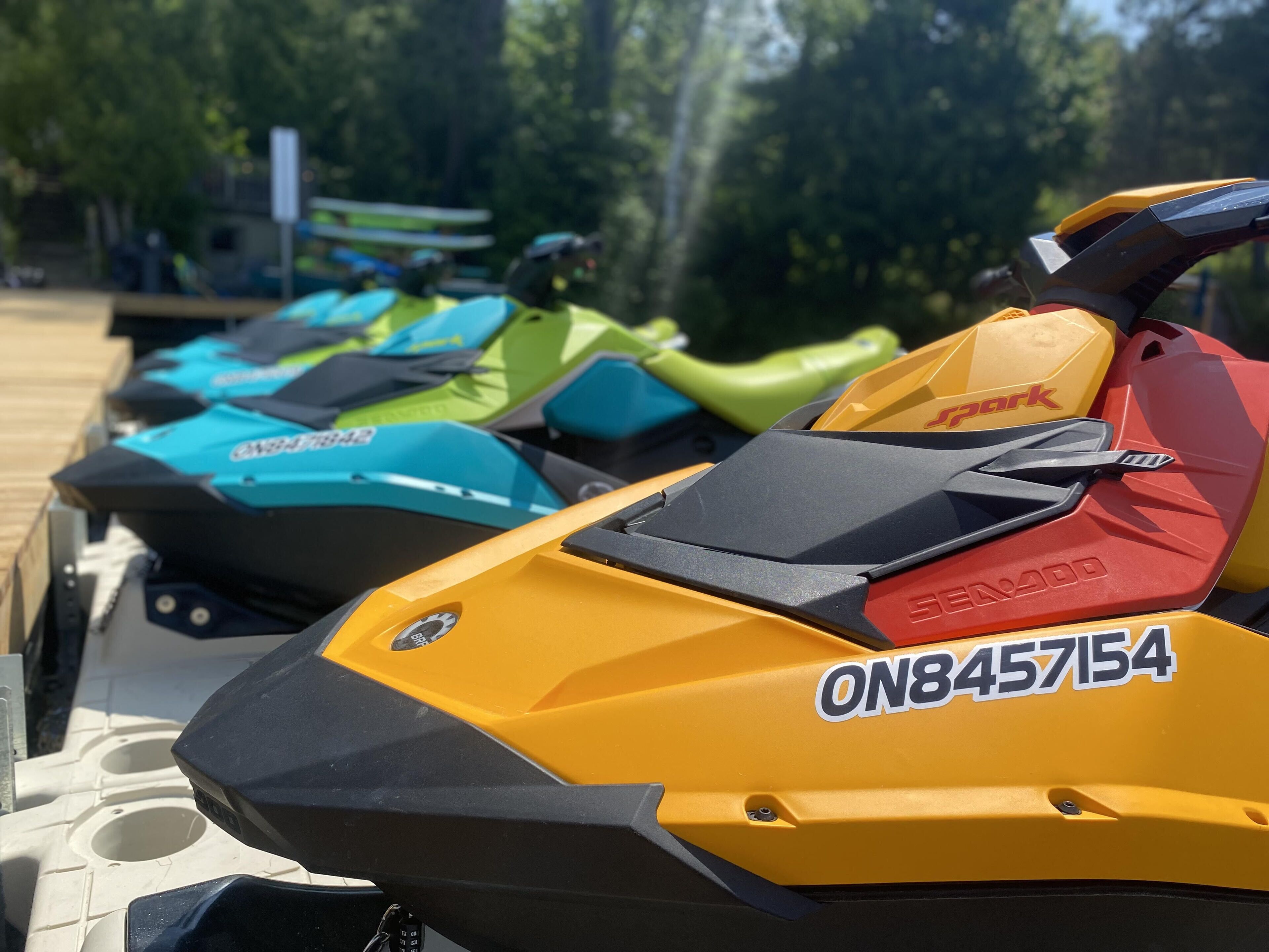 A row of jet skis parked on a dock.