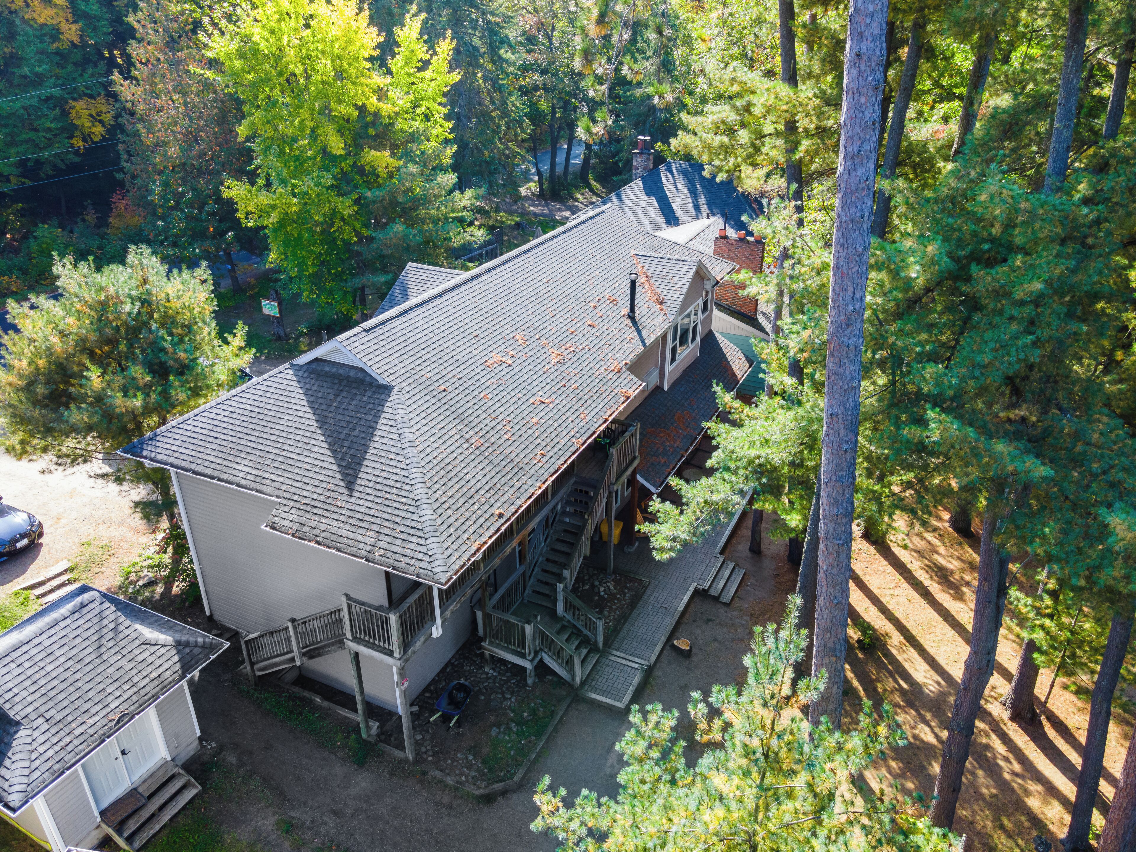 A two-story house with a steep roof, a front porch, and a garage.