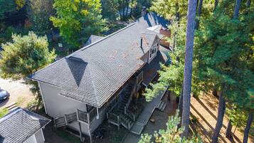 A two-story house with a steep roof, a front porch, and a garage.
