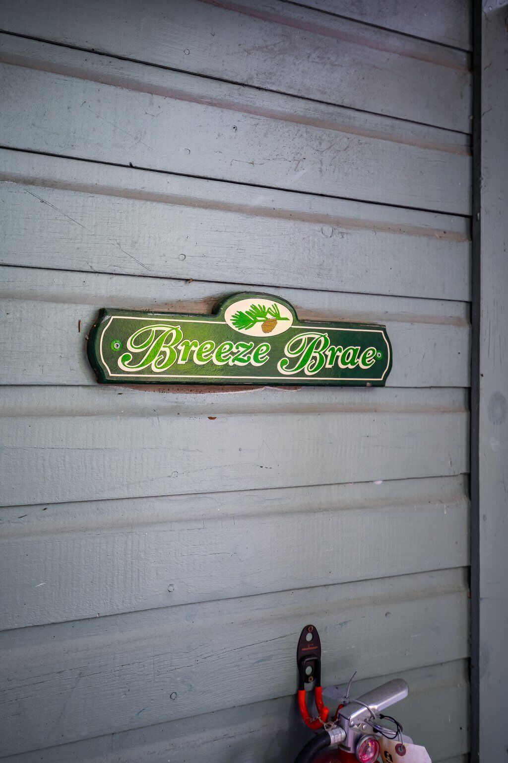 A wooden wall with a sign that reads "Breeze Brae."