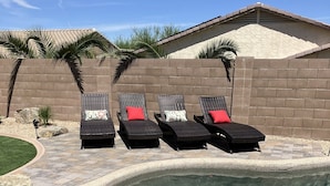 A swimming pool with clear water, surrounded by a brick wall and palm trees. - Young Desert Oasis with Heated Pool in Estrella Mountain Ranch (Goodyear)