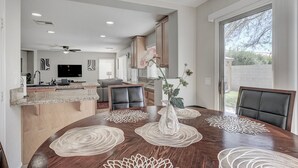 A modern kitchen with a dining area, a TV, and a large window. - King Suite -Spa- Fast Wifi (Las Vegas)