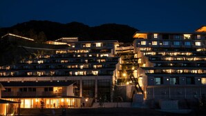 A multi-story hotel with balconies and a dining area. - Hotel Vison (Taki)