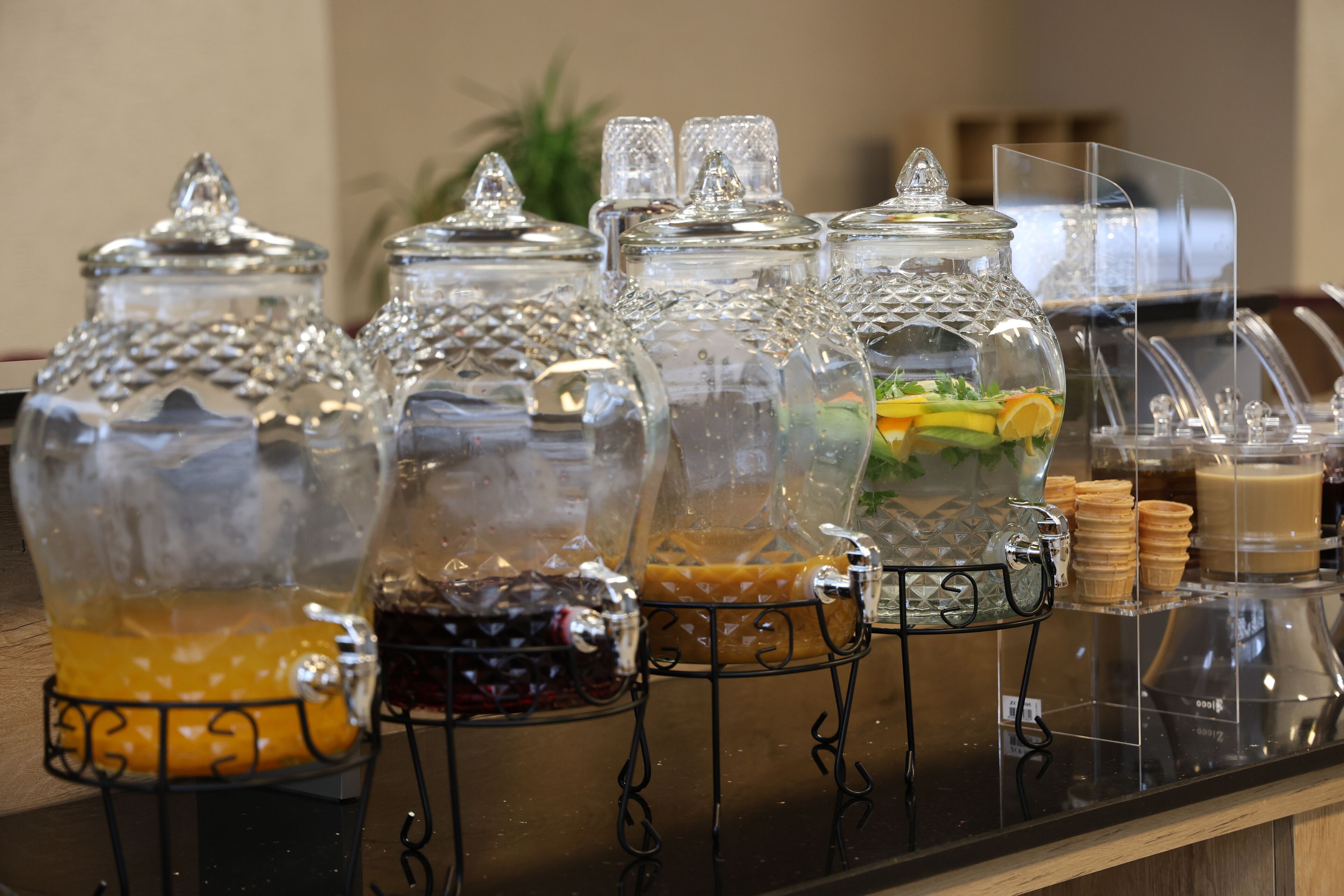 A beverage station with various drink dispensers and a salad bar.