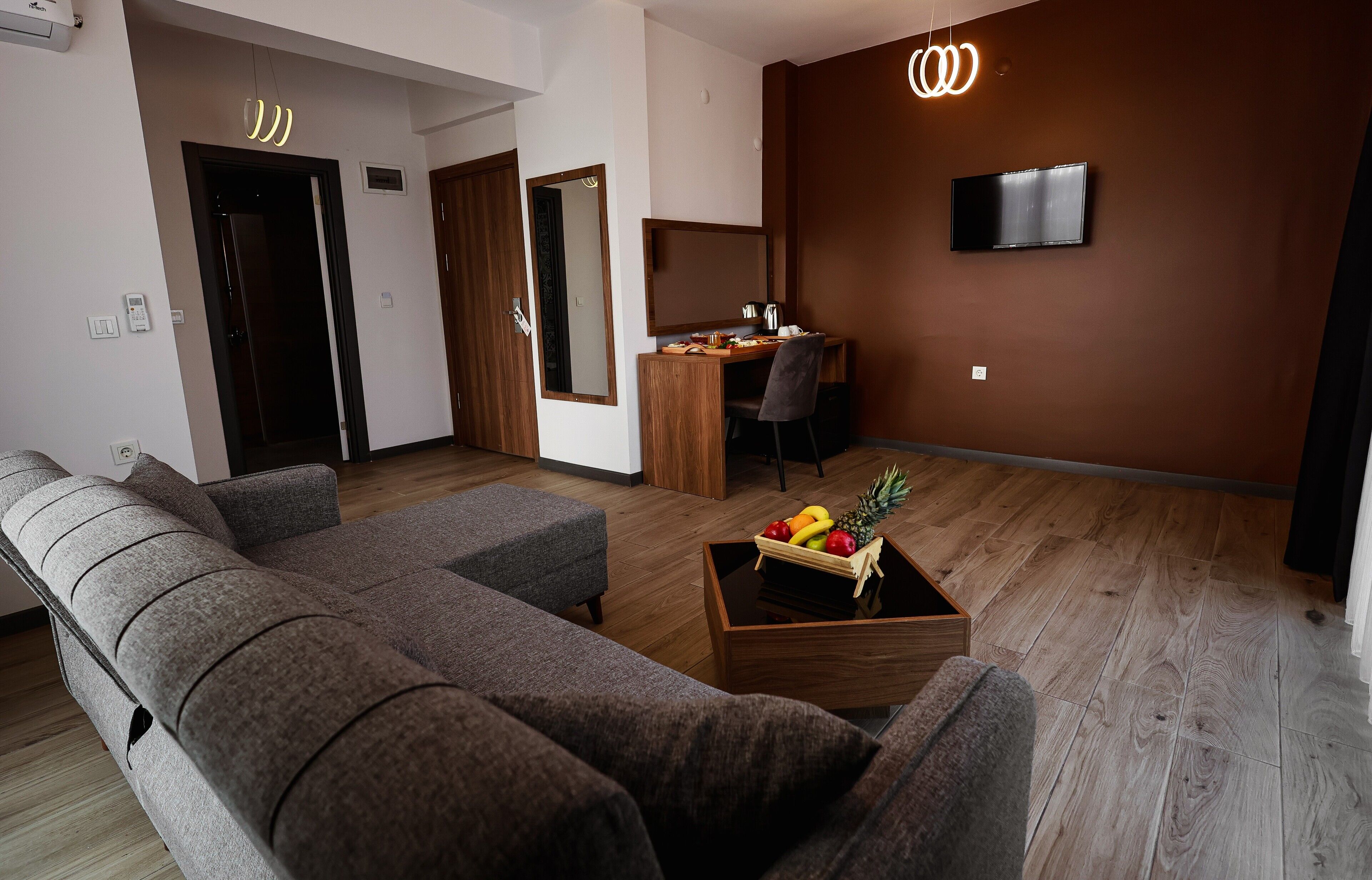 Deluxe Room | Living area | 82-inch LCD TV with cable channels, TV, printers