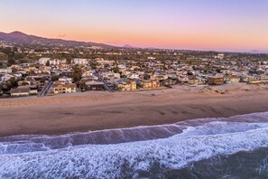A coastal town with a beach, houses, and a mountain in the background. - Luxury Beach House 99 Steps from Sand, Pet-friendly (Ventura)