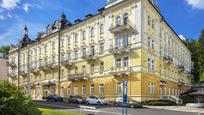 A historic building with ornate architecture, multiple balconies, and a prominent tower. - Reitenberger Spa Medical (Marianske Lazne)