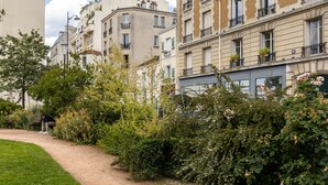 A pathway in a garden area with buildings on one side. - Picture Postcard, by Veeve (Paris)