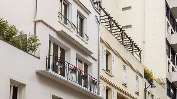 A row of white buildings with balconies, a street, and pedestrians. - Picture Postcard, by Veeve (Paris)