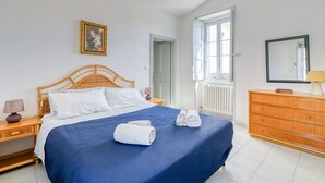 A bedroom with a bed, wooden dresser, and a window. - "Casa in Via Seminario" Apartment with Balcony and Wi-Fi (Otranto)