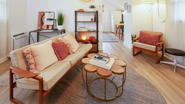 Ein modernes Wohnzimmer mit einer Couch, einem Couchtisch und einem Bücherregal.