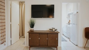 A modern kitchen with white cabinets, a built-in oven, and a refrigerator. - Located in a scenic area perfect for travelers along I-5. You are right by the Rogue River, offering stunning views and tranquility, yet conveniently positioned for easy travel access. (Gold Hill)