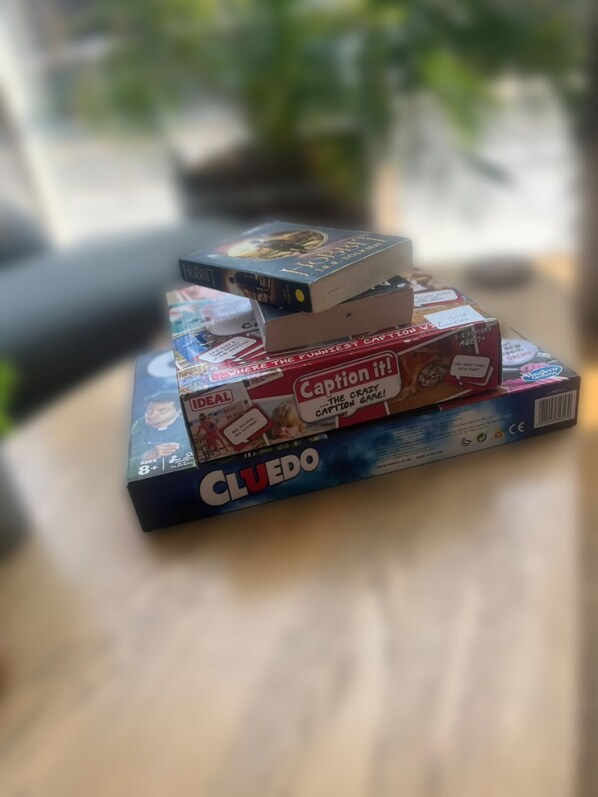 A stack of board games on a table. - Bright & Airy 3BR Home with Parking (Sheffield)