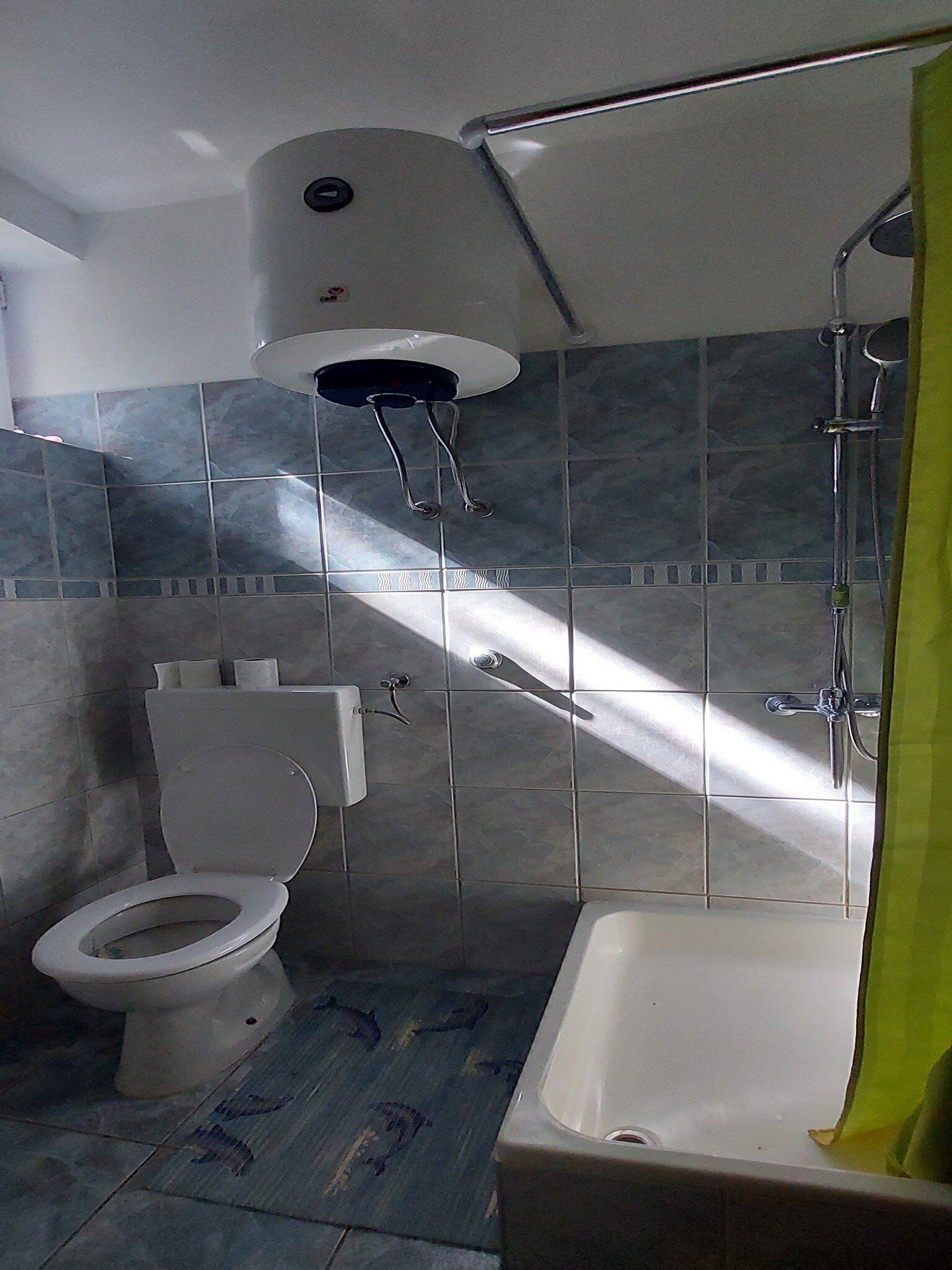 A bathroom with a toilet, a bathtub, and a shower.
