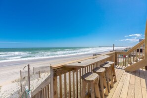 A wooden deck with a view of the beach and ocean. - Beach Barn Lower - Lovely 3BR Lower Unit on the Oceanfront (Surf City)