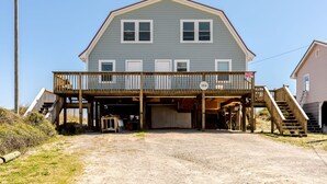 A two-story house with a covered front porch and a garage.