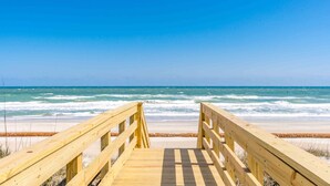 A wooden boardwalk leading to a beach with waves. - Shoreside Cottage - Classic 2 BR Beauty - Amazing Views from Covered Porch! Dog (Surf City)