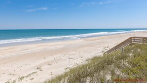 A beach with a wooden walkway leading to the water, sandy dunes, and a clear blue sky. - Shoreside Cottage - Classic 2 BR Beauty - Amazing Views from Covered Porch! Dog (Surf City)