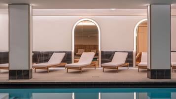 A poolside area with lounge chairs and a view of the pool.