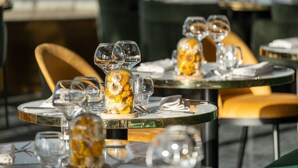 A dining table set with multiple wine glasses and a centerpiece with flowers. - Radisson Blu Grand Hotel & Spa, Malo-Les-Bains (Dunkirk)