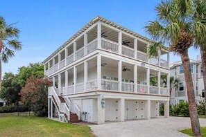 A multi-story building with balconies, a covered walkway, and a staircase.
