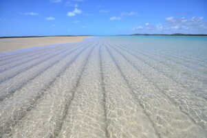 On the beach, white sand, free beach cabanas, sun loungers