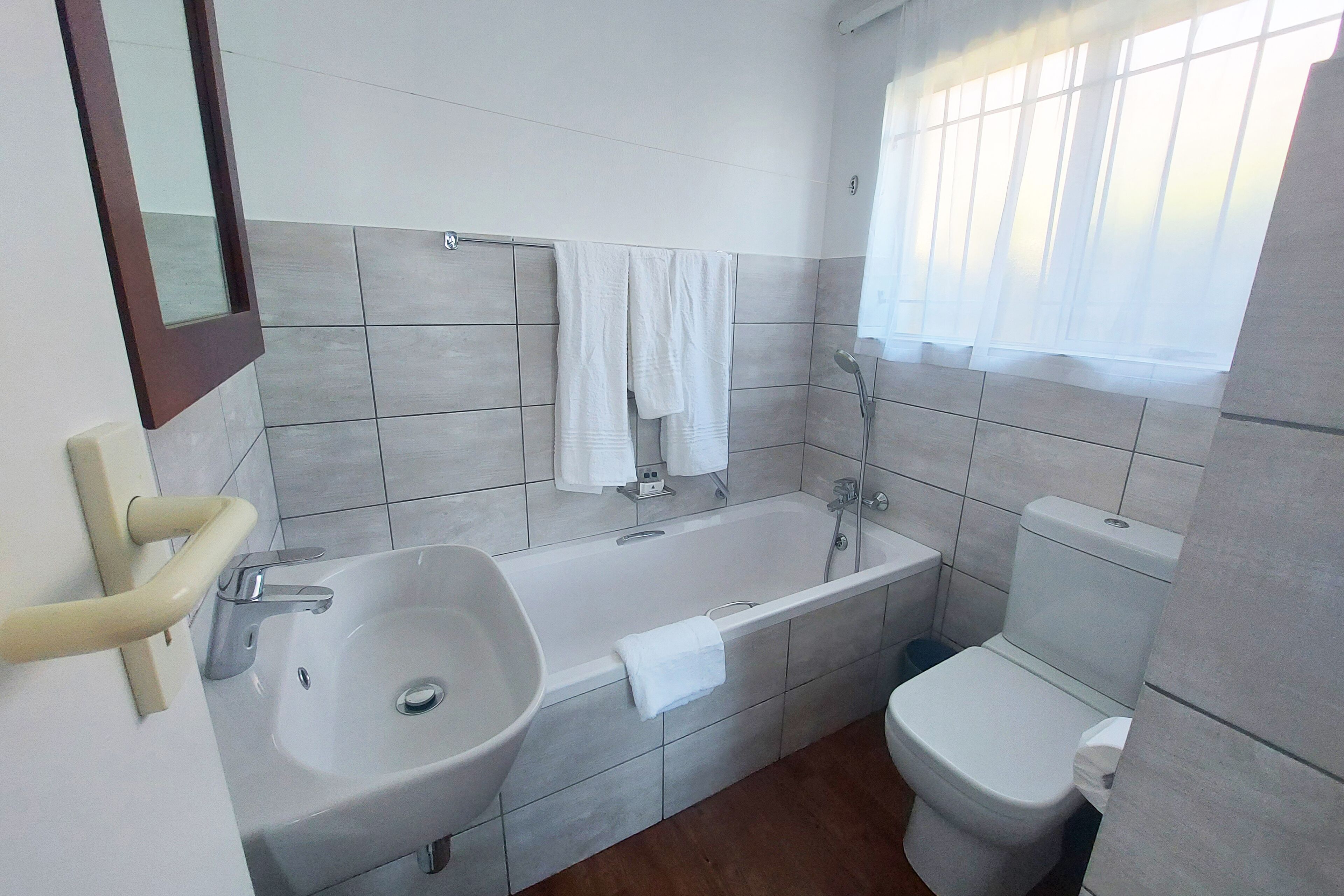 A bathroom with a bathtub, sink, and toilet.