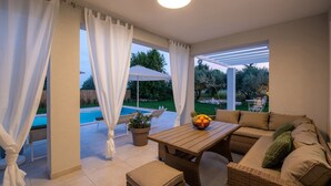 A sunlit patio with a pool, outdoor furniture, and a view of the garden. - Lovely Villa Oliveti with a swimming pool (Frata)
