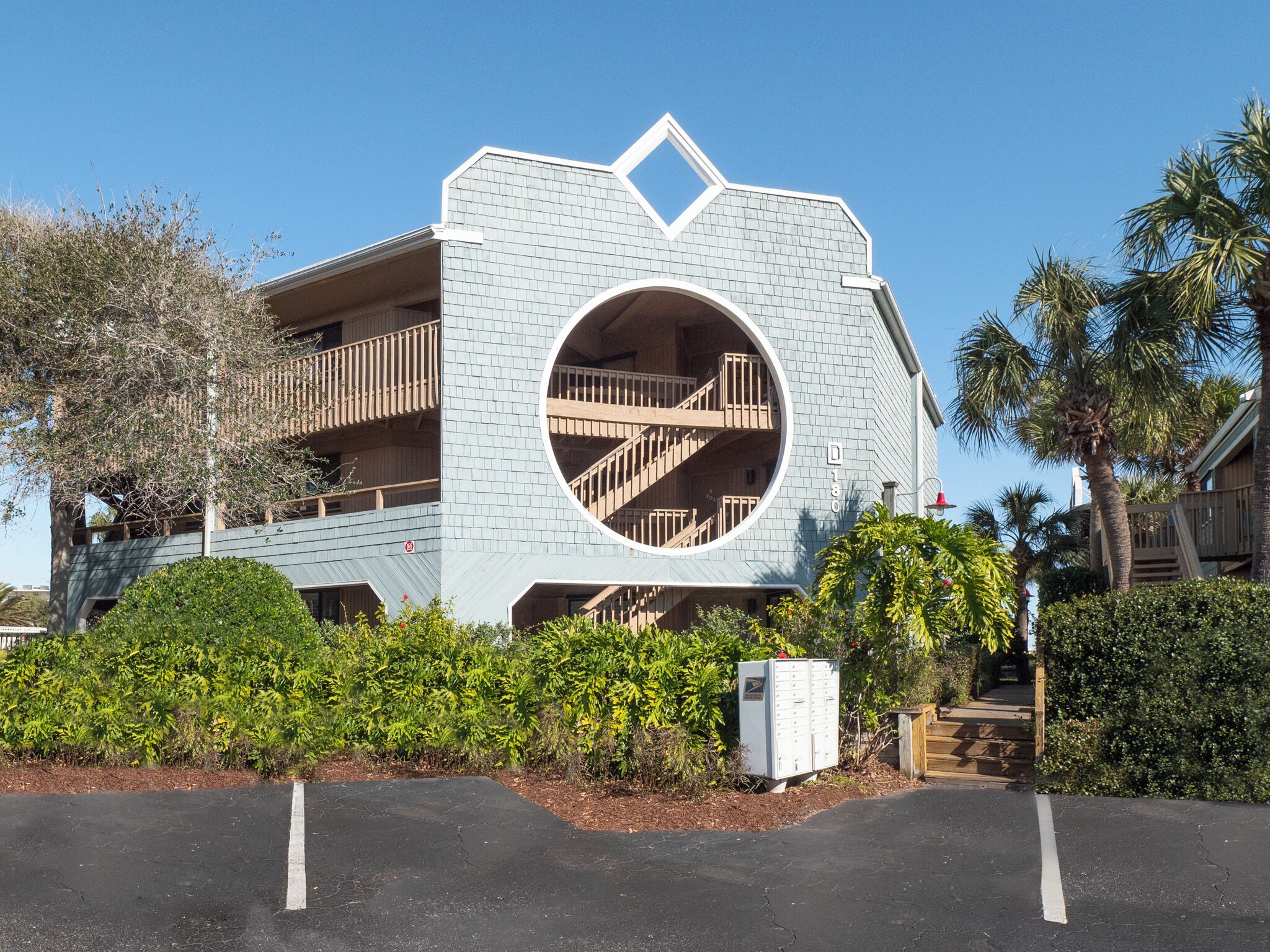 A modern building with a circular window and a balcony.