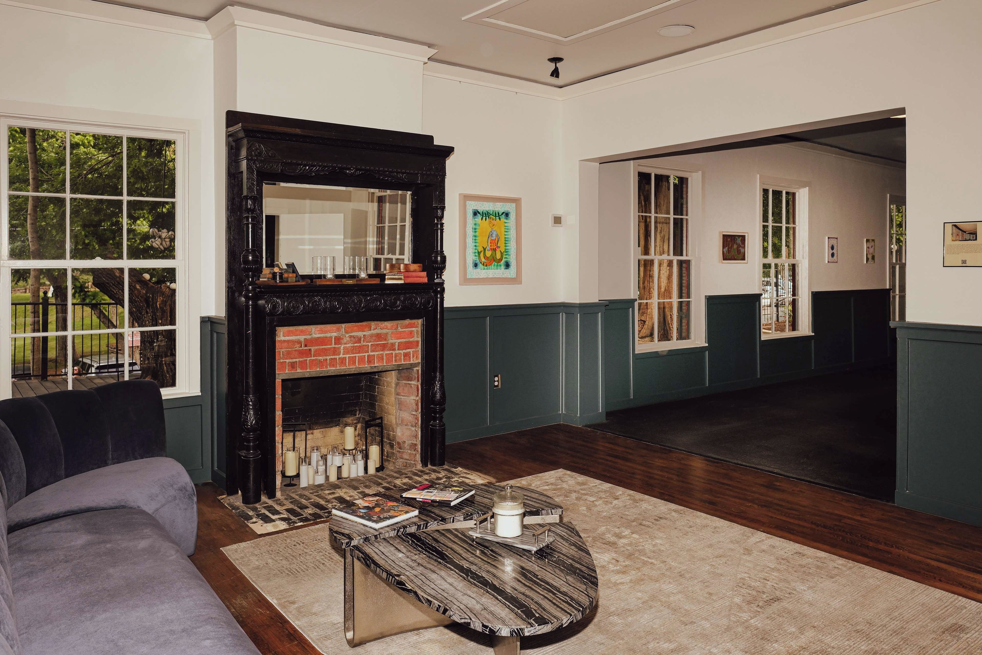 A living room with a fireplace, a sofa, and a coffee table.