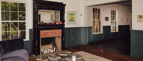 A living room with a fireplace, a sofa, and a coffee table.
