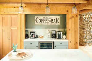 A coffee bar with a sign reading "The Chalet Coffee Bar" and various coffee-making equipment.